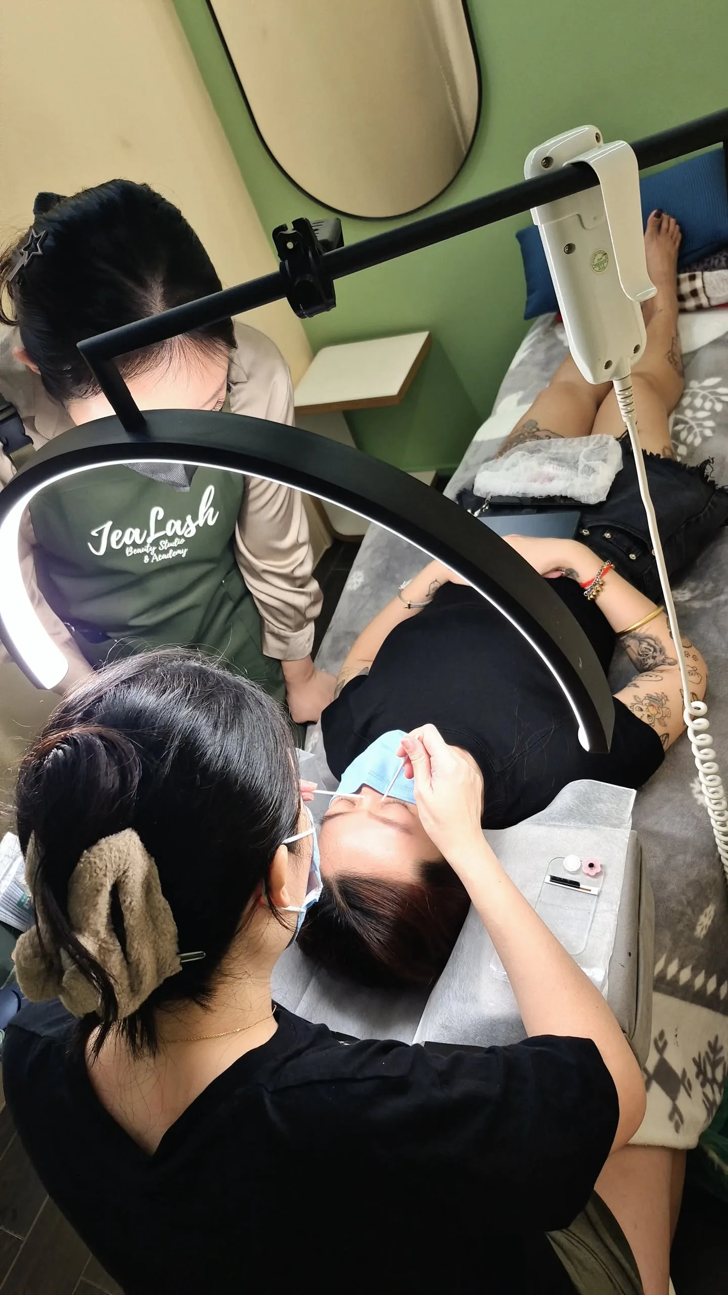 Student practising eyelash extensions on a live model during Jealash training