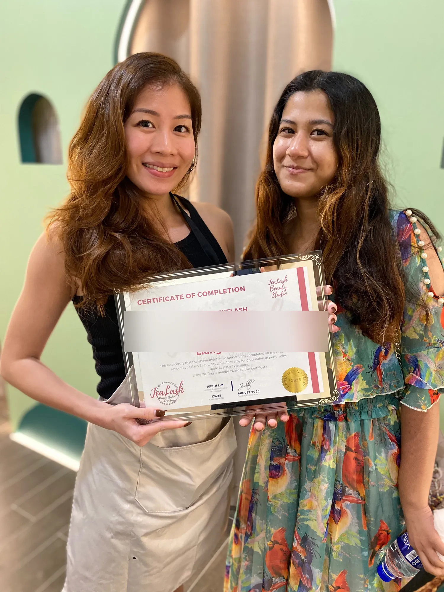 Jealash Basic Eyelash Extensions graduate with the student name obscured for privacy