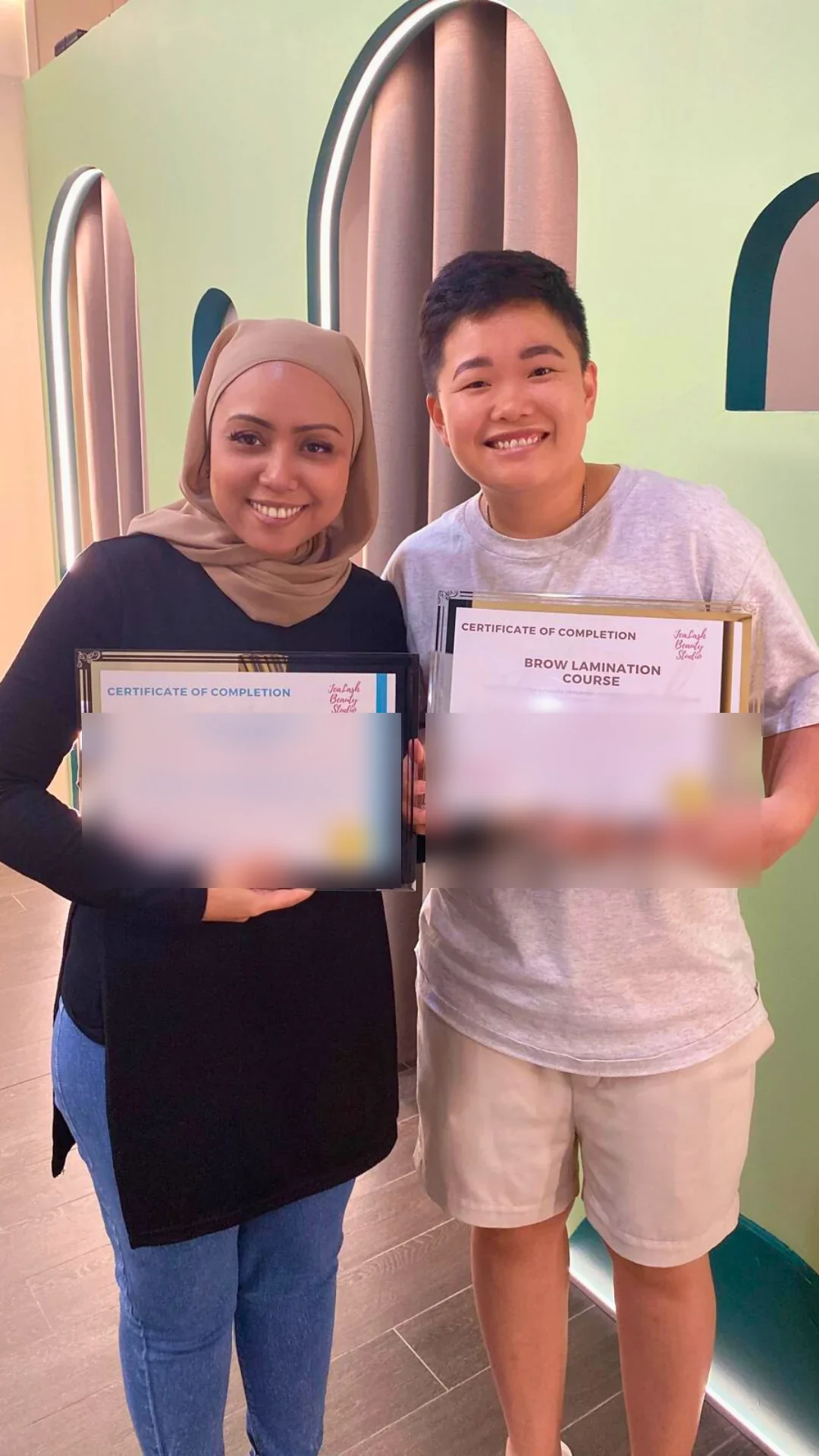 Jealash graduate holding a privacy-blurred course completion certificate