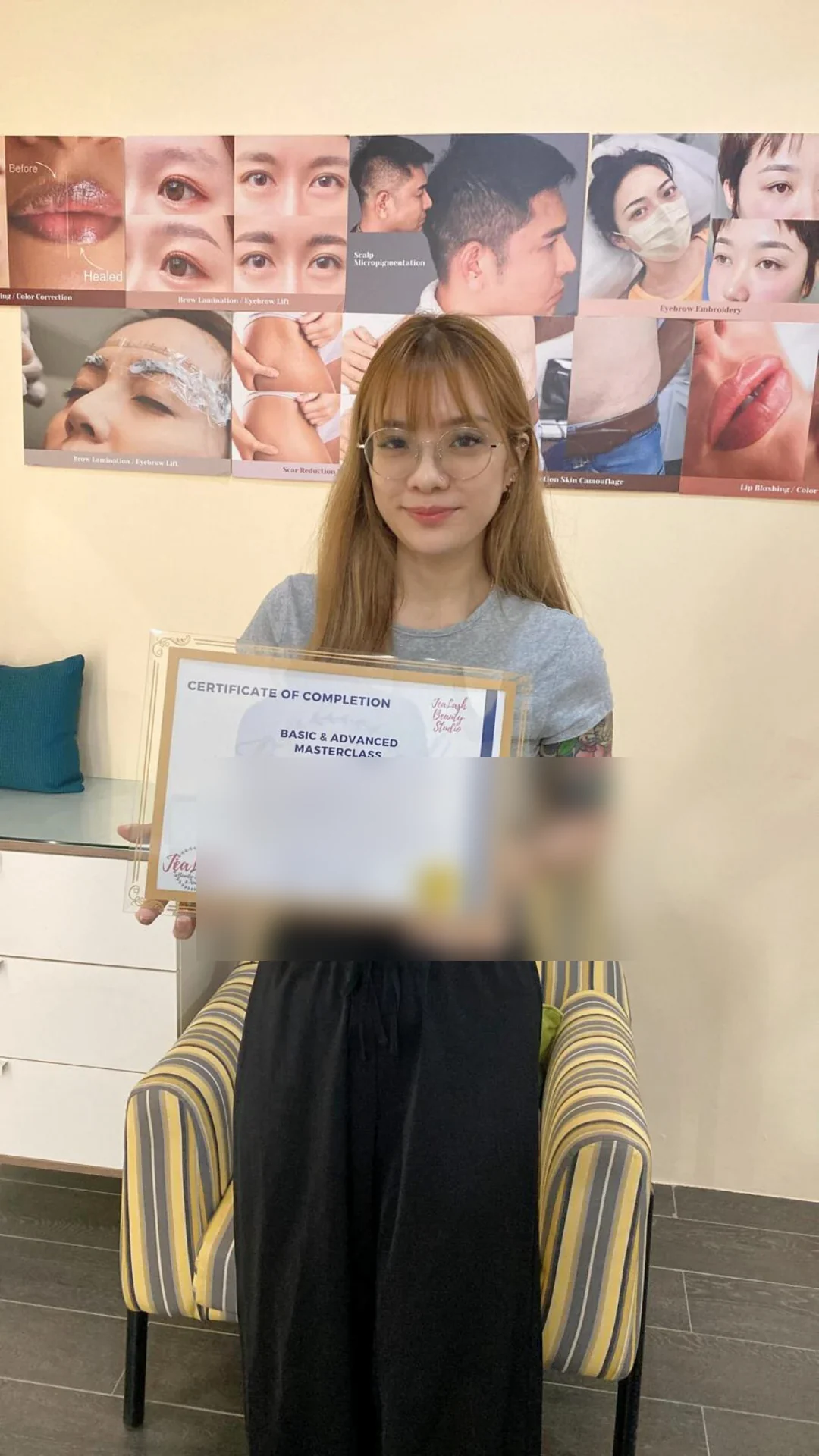 Jealash graduate holding a privacy-blurred course completion certificate