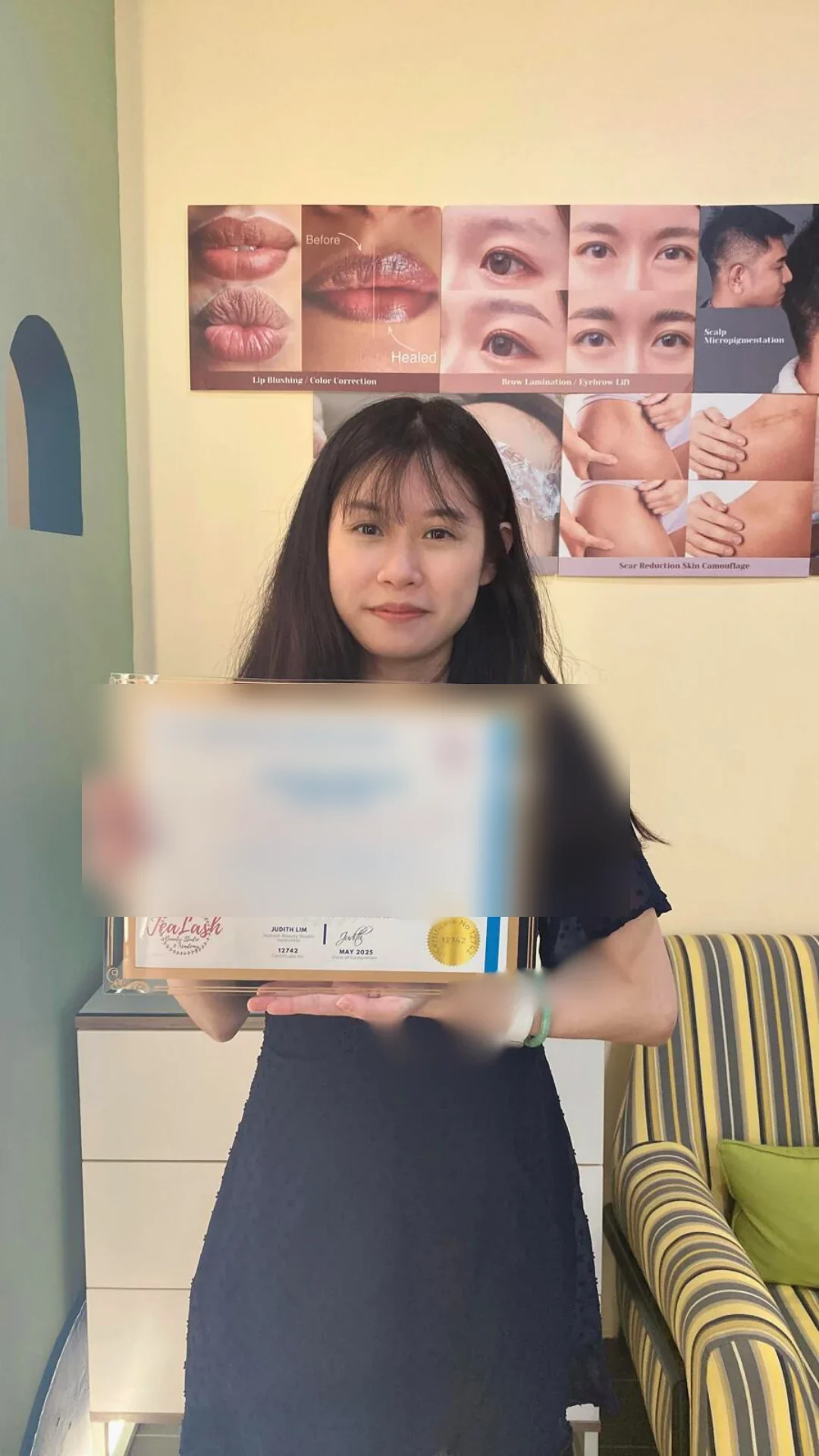 Jealash graduate holding a privacy-blurred course completion certificate