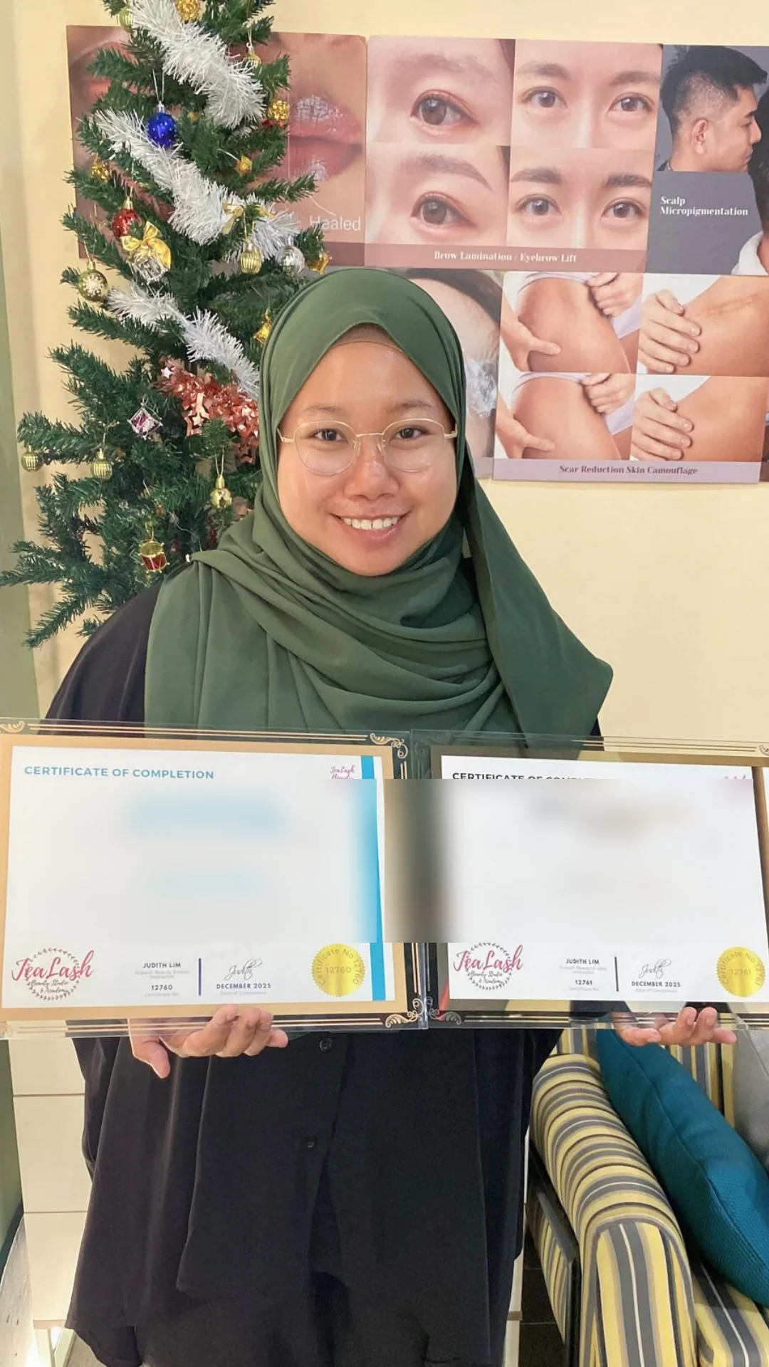 Jealash graduate holding a privacy-blurred course completion certificate