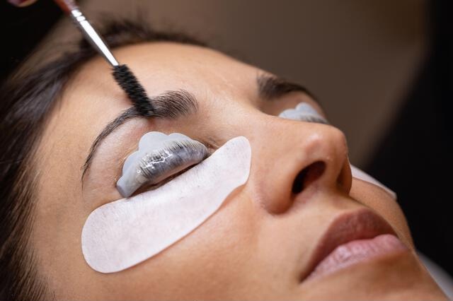 Lash tint being applied close to the lash roots